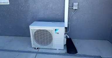 Professional ductless mini-split outdoor unit installation by HVAC Penguin showing proper mounting and line connections