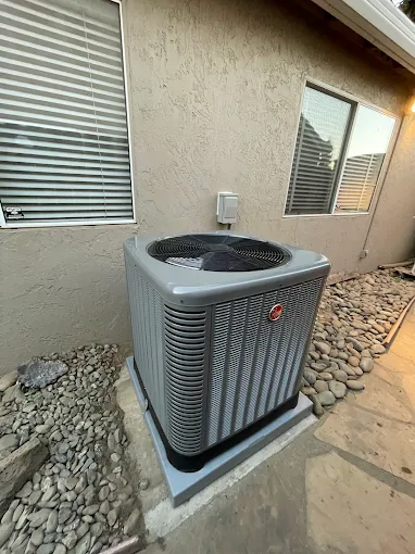 Residential heat pump installation in Turlock backyard with proper clearances and professional setup